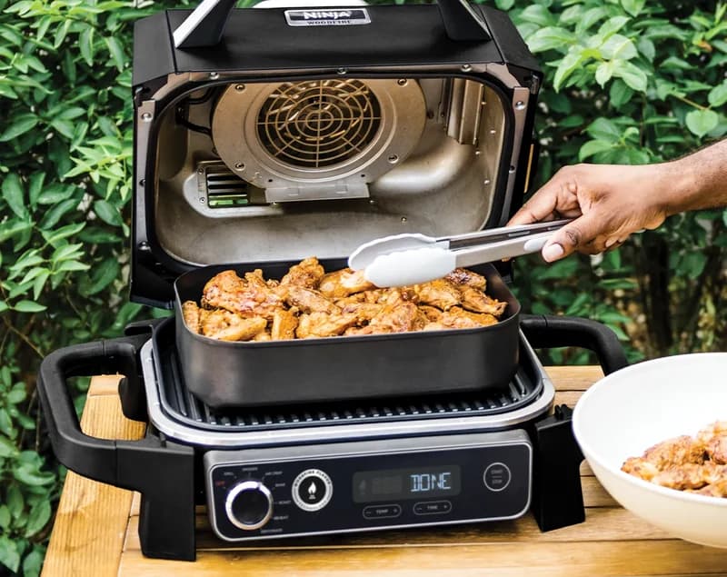 Air fried chicken wings in the Ninja Woodfire pan, display reading DONE